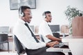 African american customer support operator with hands-free headset working in the office Royalty Free Stock Photo