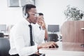 African american customer support operator with hands-free headset working in the office Royalty Free Stock Photo