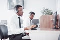 African american customer support operator with hands-free headset working in the office Royalty Free Stock Photo