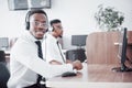 African american customer support operator with hands-free headset working in the office Royalty Free Stock Photo