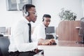 African american customer support operator with hands-free headset working in the office Royalty Free Stock Photo