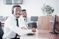 African american customer support operator with hands-free headset working in the office Royalty Free Stock Photo