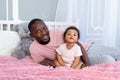 African-American dad hugs baby son at home, Father`s Day