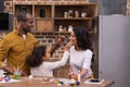 African american daughter and father painting mother face with paints, easter concept