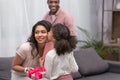 Daughter kissing mother and presenting gifts to her on mothers day Royalty Free Stock Photo