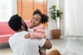 African American daughter running and hug father in the living room with smile. Multi-ethnic diverse friendly family at modern Royalty Free Stock Photo