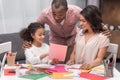 Daughter showing parents sketch of greeting card on mothers day Royalty Free Stock Photo