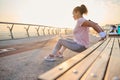 African American determined young sportswoman doing exercises on triceps, flexing her arms on a wooden bench while practicing a Royalty Free Stock Photo