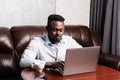 African american IT developer with laptop is programming code in office. African business man working on laptop and Royalty Free Stock Photo