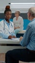 African american doctor examining x ray scan in hand Royalty Free Stock Photo