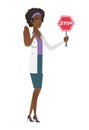 African-american doctor holding stop road sign.