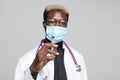 African American doctor holding syringe. attractive young doctor on gray background Royalty Free Stock Photo