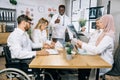 Team of five diverse medical workers having meeting at office Royalty Free Stock Photo