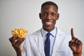 African american doctor man holding bowl with macaroni pasta over isolated white background surprised with an idea or question Royalty Free Stock Photo