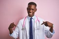 African american doctor man wearing stethoscope standing over isolated pink background looking confident with smile on face, Royalty Free Stock Photo