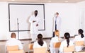 African american doctor in protective mask speaking in conference room Royalty Free Stock Photo