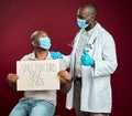 African american doctor showing thumbs up sign and symbol after covid vaccine to black man wearing face mask. Patient Royalty Free Stock Photo