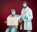 African american doctor showing thumbs up sign and symbol after covid vaccine to black man wearing face mask. Patient Royalty Free Stock Photo