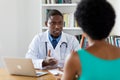 African american doctor talking about cancer with patient
