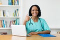 African american doctor talking online with patients Royalty Free Stock Photo