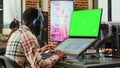 African american editor using greenscreen template on monitor