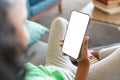 African american elementary girl using smart phone with copy space while sitting on couch in school