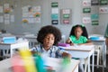 African american elementary school students studying at desk in classroom Royalty Free Stock Photo