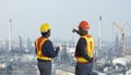 African American engineer is discussing on furture plan while looking over the petroleum and crude oil refinery factory for power Royalty Free Stock Photo