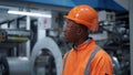 African american engineer looking camera in industrial manufacturing factory Royalty Free Stock Photo