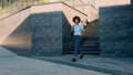 African American ethnic woman walking in city downtown drinking tea businesswoman girl fashionable trendy female Royalty Free Stock Photo