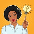 African american excited businesswoman pointing on lightning bulb, idea concept vector illustration in pop art style eps10