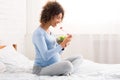 African-american expectant girl enjoying healthy vegetable salad Royalty Free Stock Photo