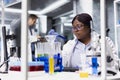African american expert working for bioscience with modern lab tools Royalty Free Stock Photo