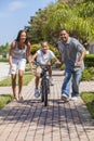 African American Family WIth Boy Riding Bike & Happy Parents Royalty Free Stock Photo