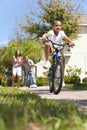 African American Family Boy Riding Bike & Parents Royalty Free Stock Photo