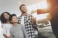 African american family at car dealership. Salesman is giving keys for new car. Royalty Free Stock Photo