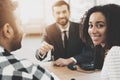 African american family at car dealership. Salesman is presenting keys for new car. Royalty Free Stock Photo