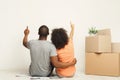 Black couple looking up, sitting on floor Royalty Free Stock Photo