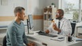 African American Family Doctor is Talking with Young Male Patient During Consultation in a Health Royalty Free Stock Photo