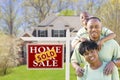 African American Family In Front of Sold Sign and House Royalty Free Stock Photo