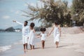 African American family. Happy family Mother, Father, Two daughters walking and playing together on the beach on holiday, having Royalty Free Stock Photo