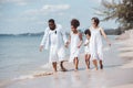 African American family. Happy family Mother, Father, Two daughters walking and playing together on the beach on holiday, having Royalty Free Stock Photo