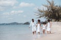 African American family. Happy family Mother, Father, Two daughters walking and playing together on the beach on holiday, having Royalty Free Stock Photo