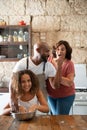 African American family having fun in their home kitchen while cooking a cake together Royalty Free Stock Photo