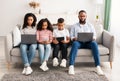 African american family holding and using gadgets Royalty Free Stock Photo