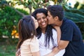 African american family hugging each other kissing at park Royalty Free Stock Photo