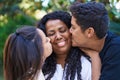 African american family hugging each other kissing at park Royalty Free Stock Photo
