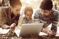 African American family in park and using laptop together. Royalty Free Stock Photo