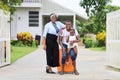 African American family is moving in to a new house with father holding baby with suitcase and baggage with smile
