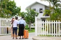 African American family is moving in to a new house with father holding baby with suitcase and baggage for housing and relocation